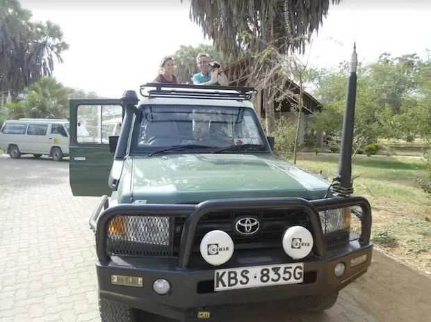 Safari Land Cruiser parked at a lodge entrance