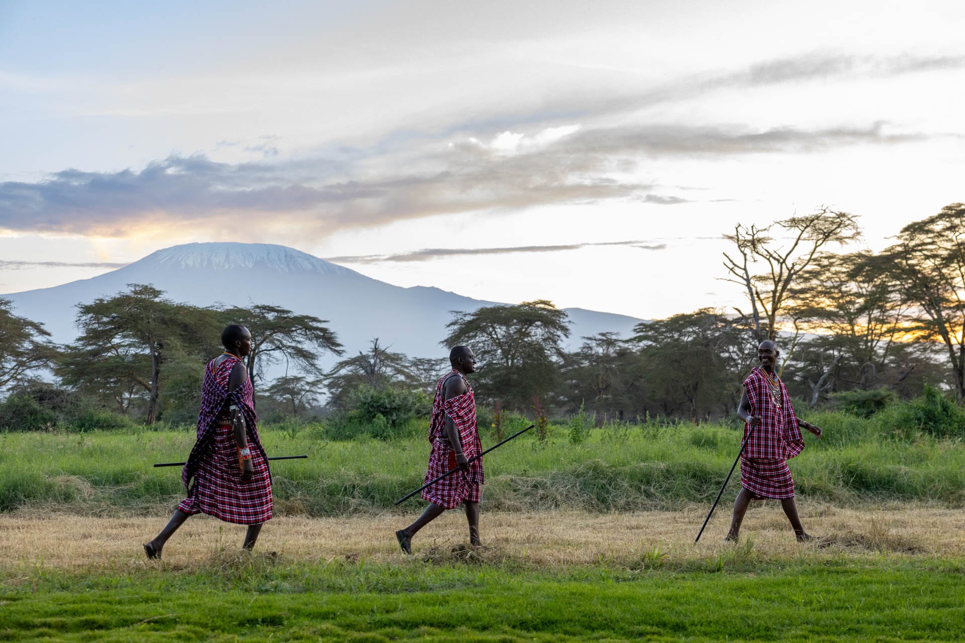Maasai men walking across the plains at sunset