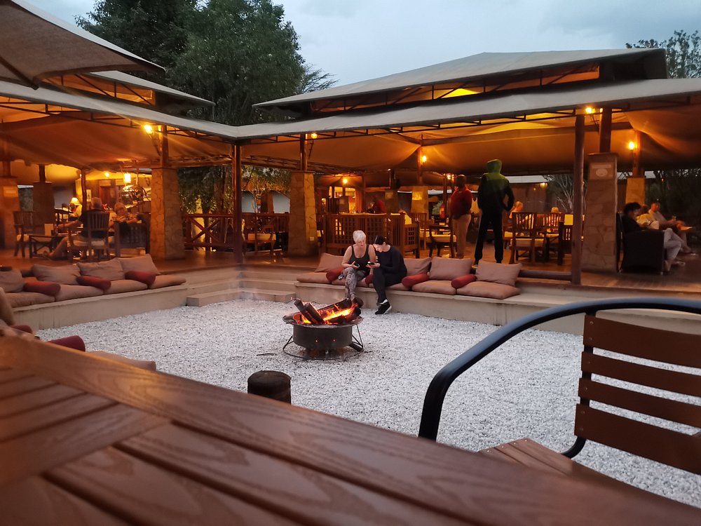 Lodge lounge and bar around an open fire pit