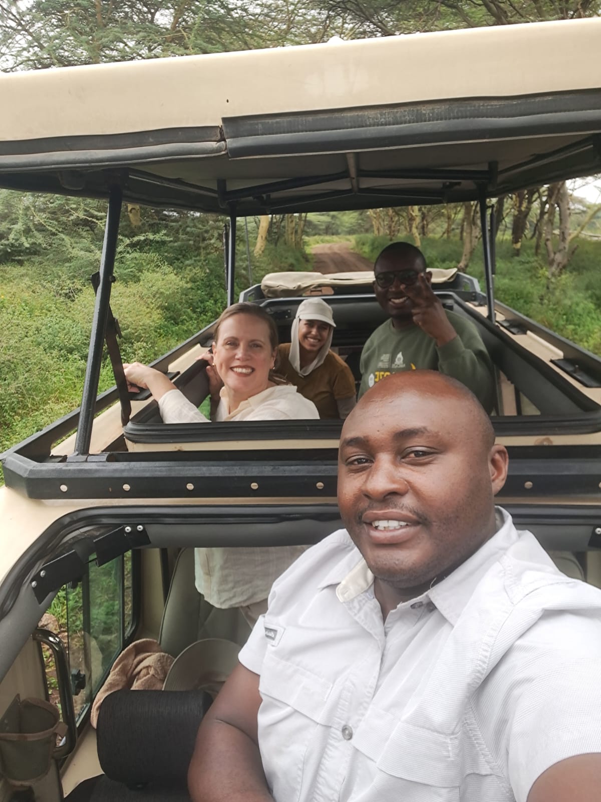 Safari guide and guests in an open vehicle