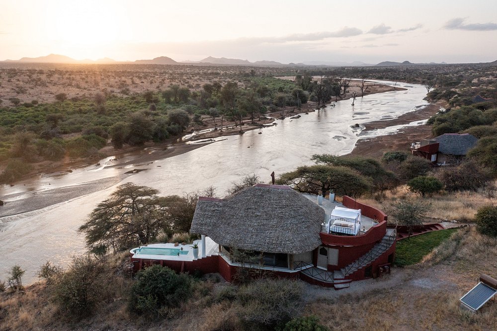 Aerial view of a lodge beside a river in dry country