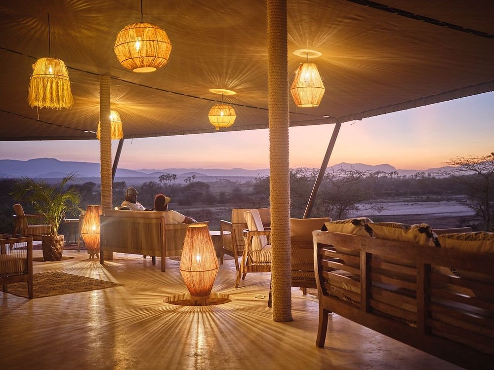 Tented camp lounge looking out over the plains at sunset