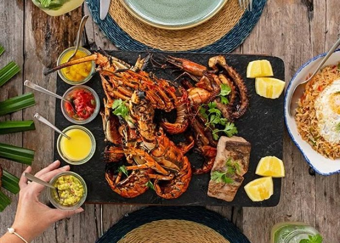Seafood platter and drinks laid out on a wooden table