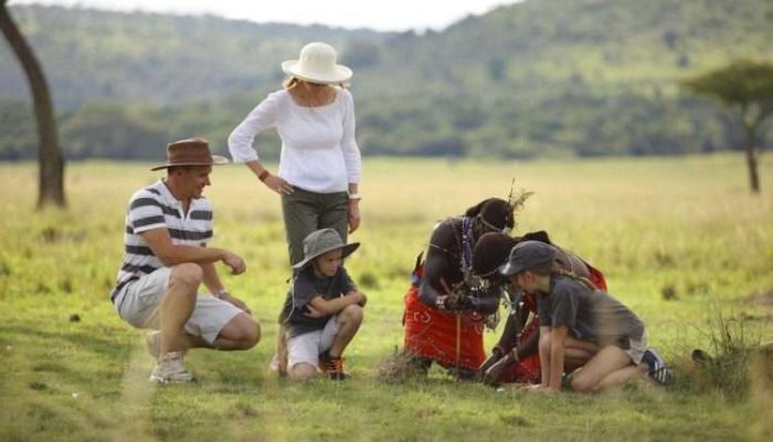 Happy family on safari at kichwa tembo camp located in Masai Mara National Reserve. Book best Africa family safaris in Kenya and Tanzania with Aether safari collection